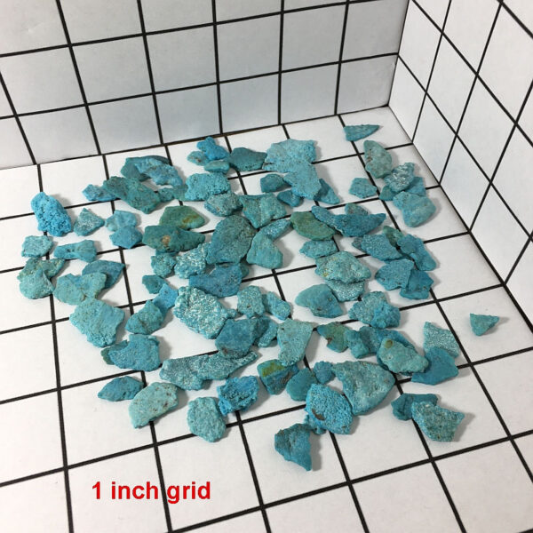 50 grams of Turquoise chips on a one inch grid. Chips range in size from approximately 0.25 to 1 inch long.