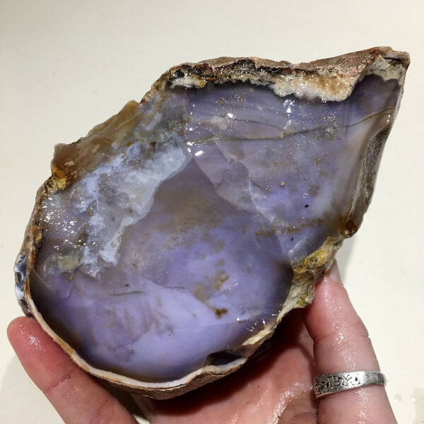 2.58 pound piece of Purple Burro Jasper rough rock, pictured wet. Side one of six sides.