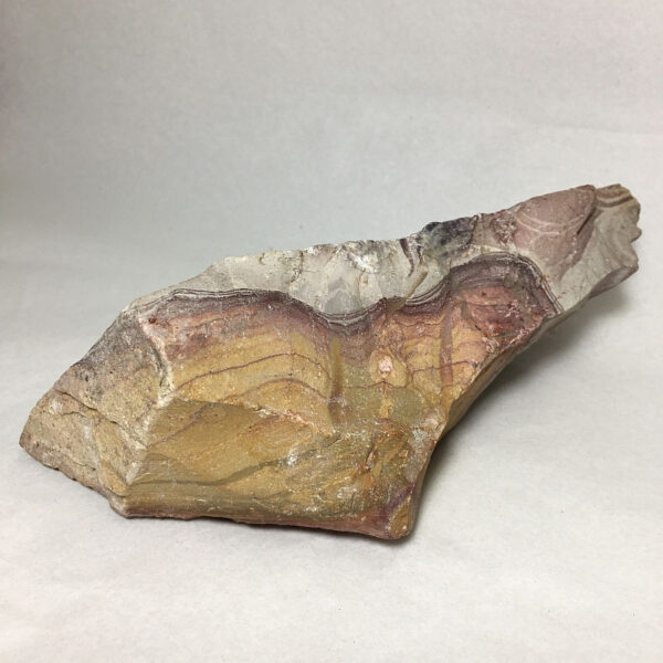 1.52 pound piece of Mexican Rhyolite rough rock, pictured dry on a white seamless background