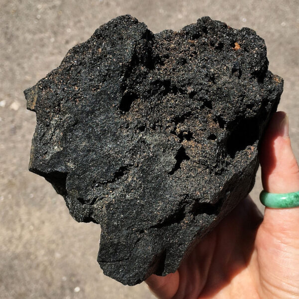 3.08 pound piece of Velvet Black Tourmaline rough rock pictured in sunlight. Side six of six sides.