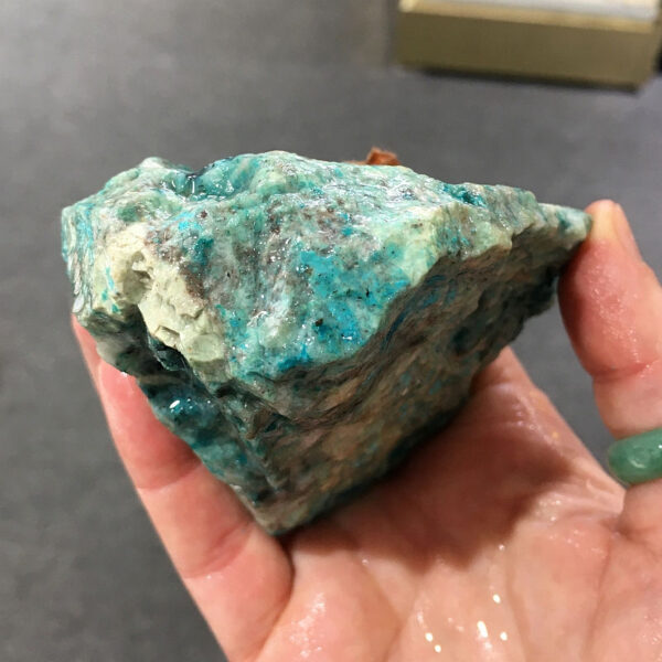 0.70 pound piece of Teal Turq Rhyolite rough rock, pictured wet. Side five of five sides.