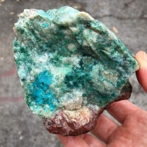 1.30 pound piece of Teal Turq Rhyolite rough rock, pictured wet. Side one of six sides.