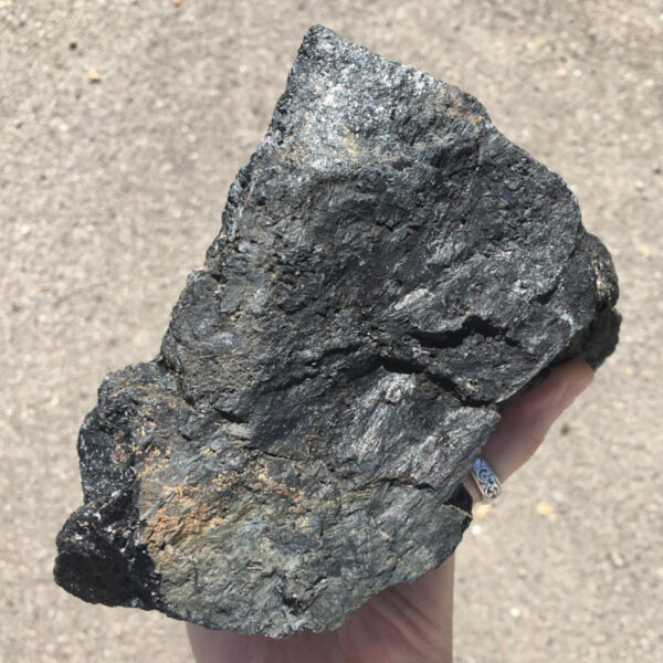 5.22 pound piece of Velvet Black Tourmaline rough rock, pictured dry in the sunlight. Side six of six sides.